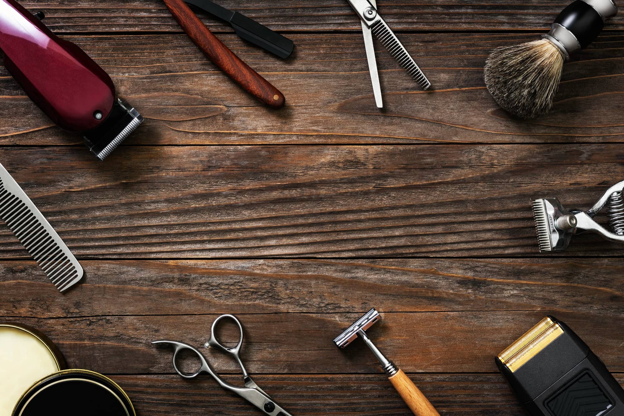 wood background surrounded by barber tools